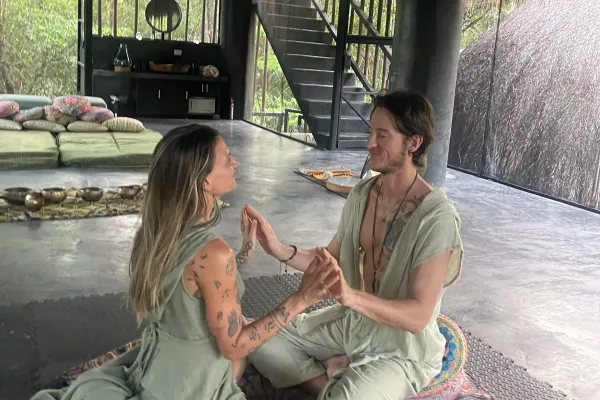 Two guests sitting close together in the retreat space at Alma Chakana